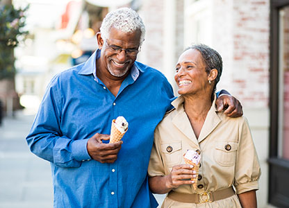 Retired couple enjoying ice cream downtown