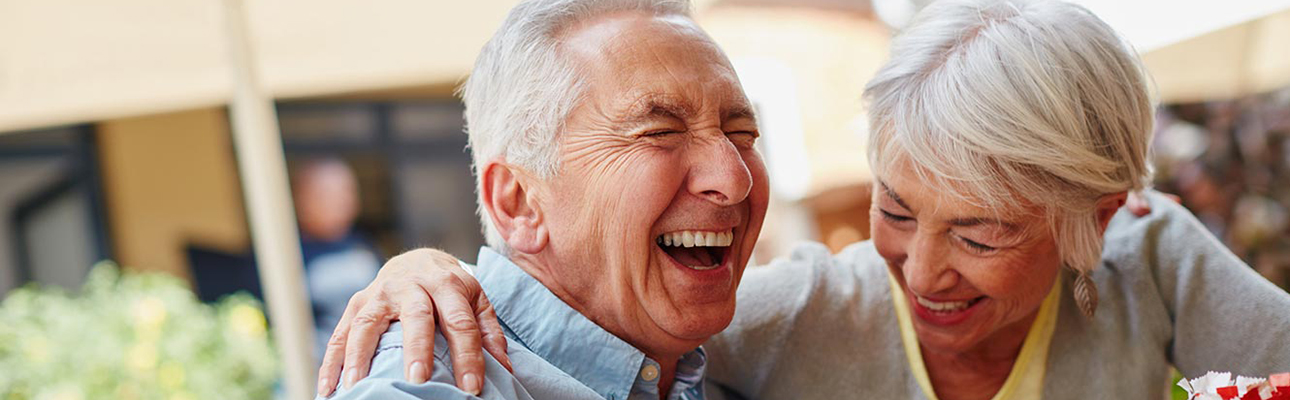 Elderly man and woman laughing
